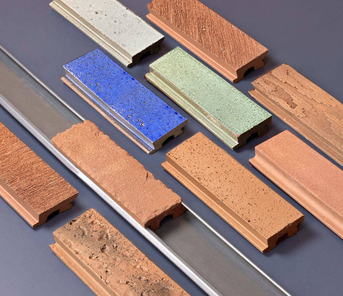Corium brick cladding system with various colored clay tiles on steel rails